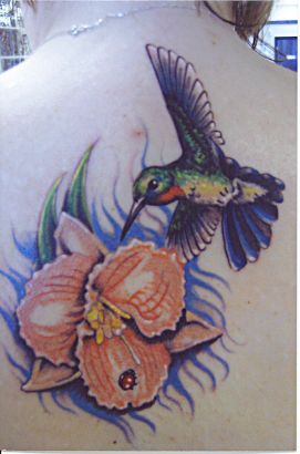 Hummingbird And Flower Pic Tattoo On Back Of Girl